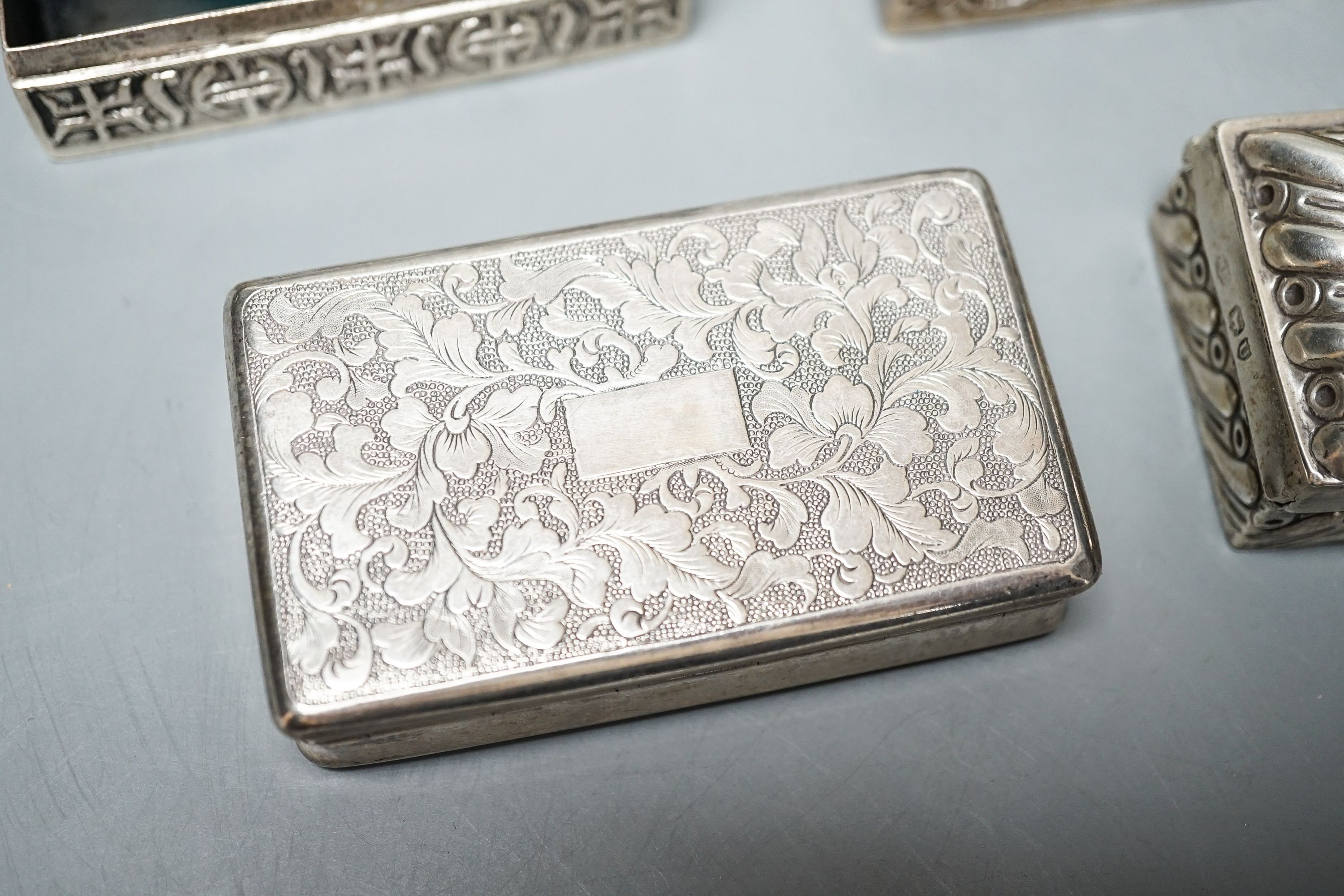 A late Victorian silver ring box, London, 1895(a.f.), 97mm, a later silver snuff box and two white metakl boxes.